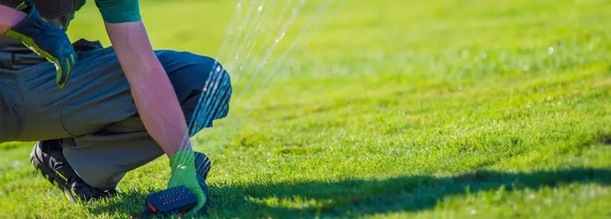 Man Adjusting Irrigation System